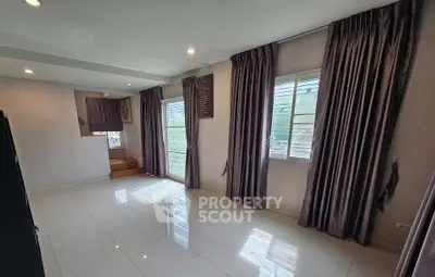 Spacious room with large windows and elegant curtains, perfect for natural light and modern living.