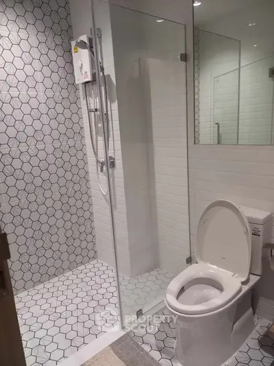 Modern bathroom with geometric tiles and glass shower enclosure