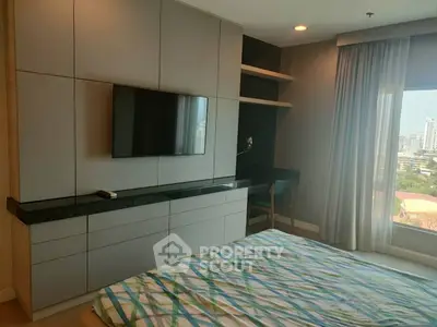 Modern bedroom with built-in TV and city view from large window