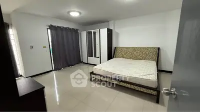 Spacious bedroom with modern furnishings and ample natural light