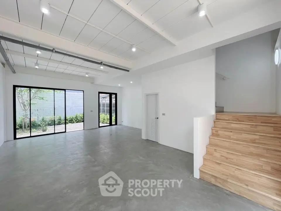 Spacious open-plan living area with modern design and large windows