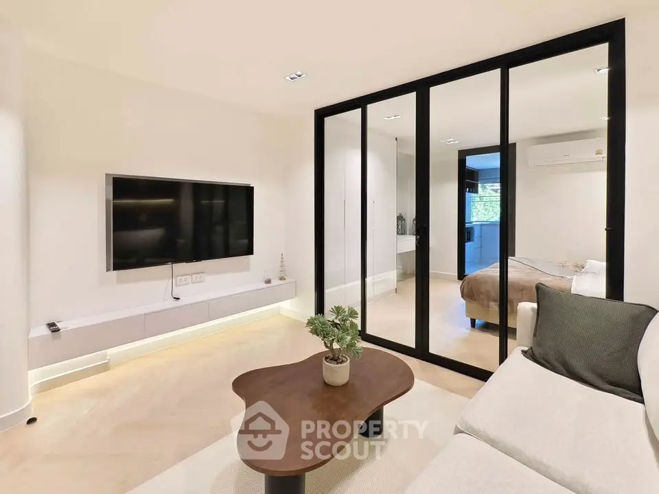 Modern living room with glass partition and sleek furniture design