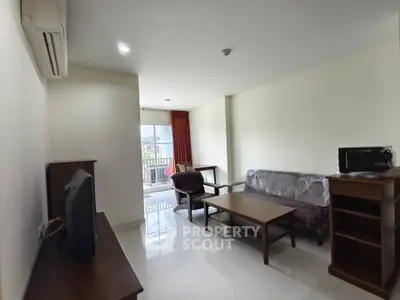 Spacious living room with modern furniture and balcony view in a bright apartment.