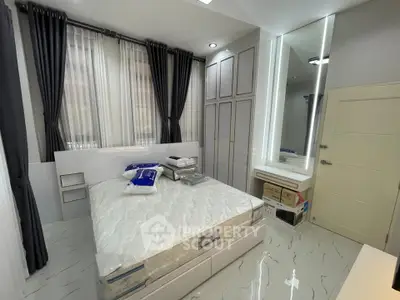 Modern bedroom with sleek design, large windows, and ample storage space.