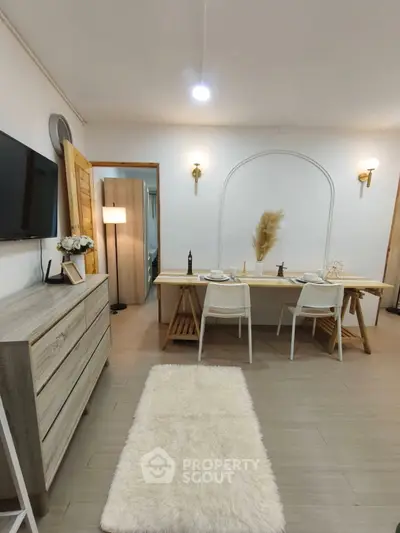 Chic living room with modern decor, featuring a cozy dining area and stylish furniture, perfect for urban living.
