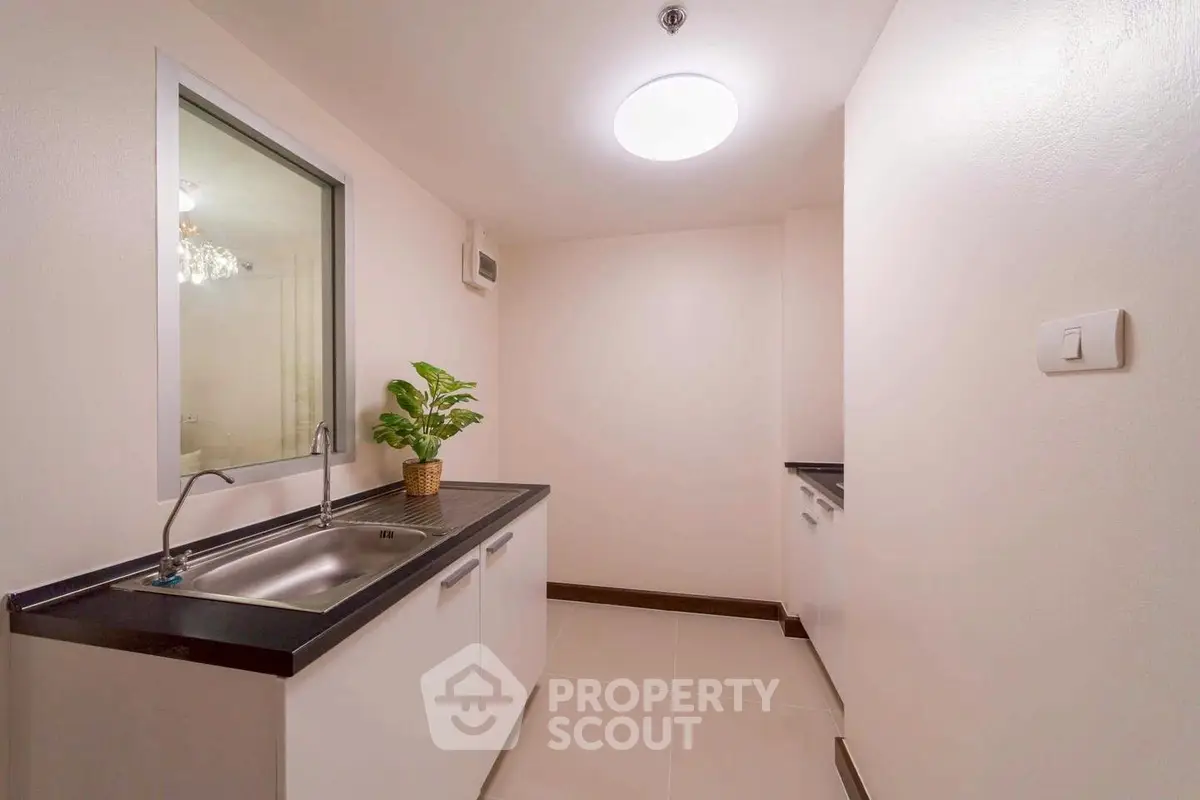 Modern minimalist kitchen with sleek countertops and stainless steel sink