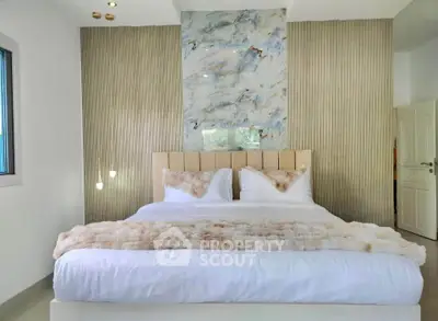 Luxurious bedroom with elegant decor and plush bedding in modern real estate property.