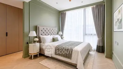 Luxurious bedroom with elegant decor and large window offering natural light.