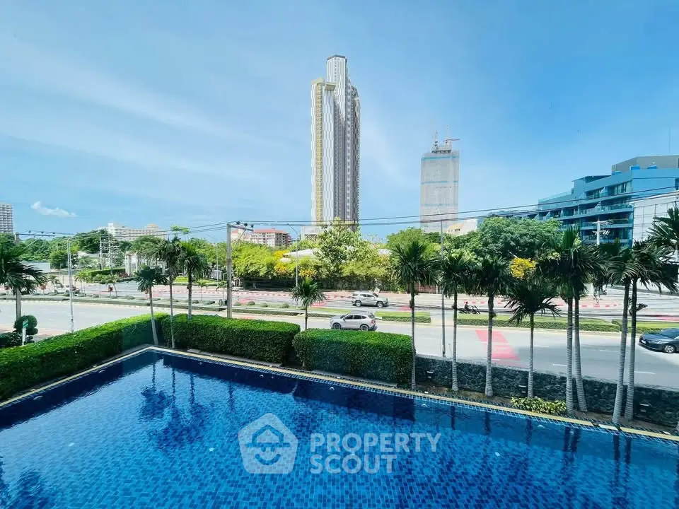 Stunning cityscape view with luxurious pool and modern high-rise buildings.