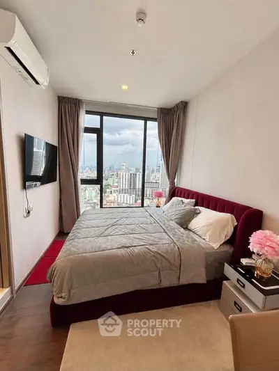 Luxurious bedroom with stunning city view, featuring modern decor and large windows for natural light.