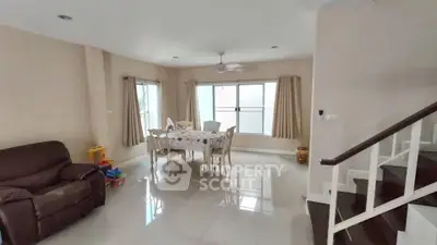 Spacious living room with dining area and staircase in modern home