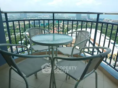 Stunning high-rise balcony with panoramic city and ocean views, perfect for relaxation and entertainment.