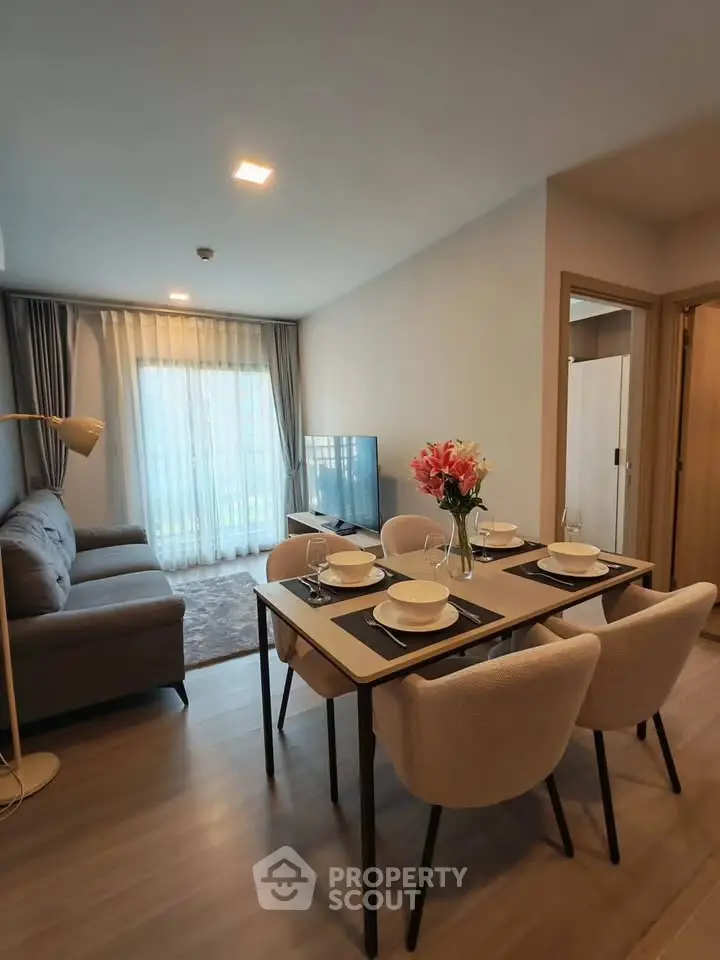Modern living room with dining area, stylish decor, and natural light.