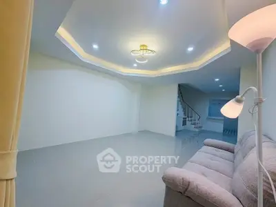 Spacious modern living room with elegant lighting and cozy sofa, perfect for relaxation and entertainment.
