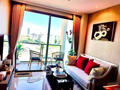 Modern living room with balcony view, stylish decor, and abundant natural light.