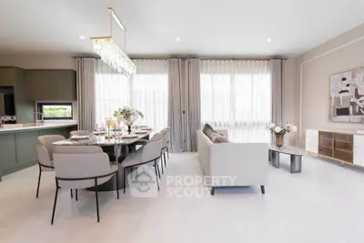 Elegant open-plan living and dining area with modern decor and ample natural light.