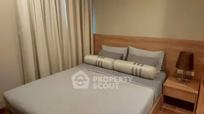 Cozy bedroom with modern decor and soft lighting, perfect for relaxation.