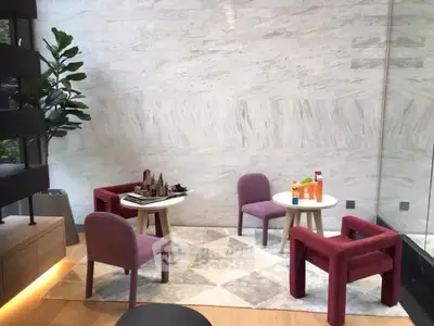 Modern living room with stylish chairs and marble wall