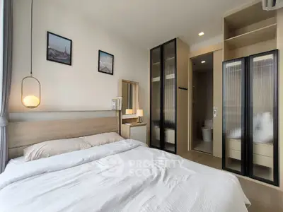 Modern bedroom with stylish decor and ensuite bathroom in a contemporary apartment.