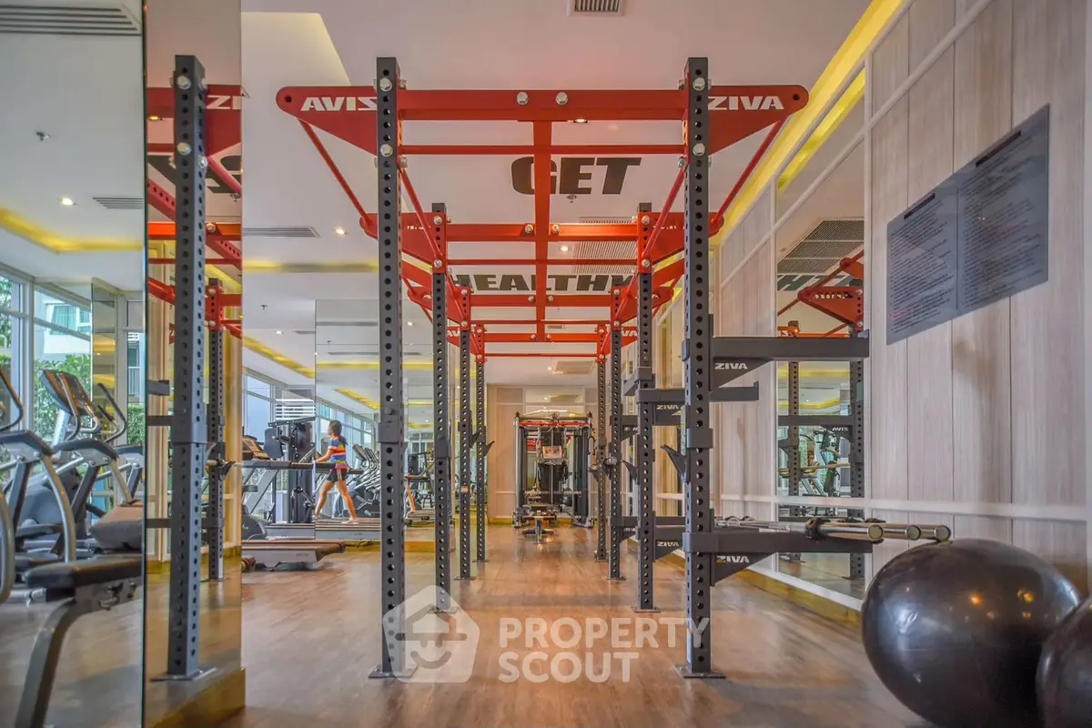 Modern gym with state-of-the-art equipment and mirrored walls for an enhanced workout experience.