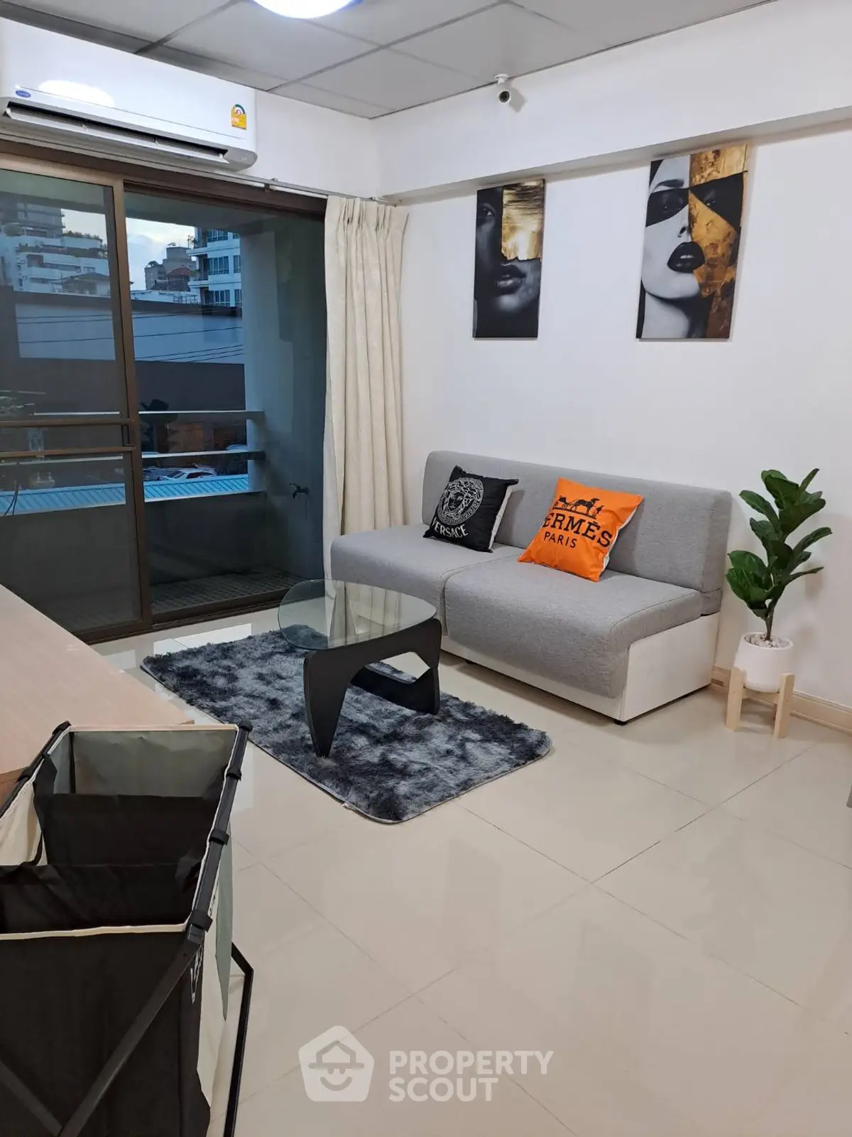 Modern living room with stylish decor and balcony view in urban apartment