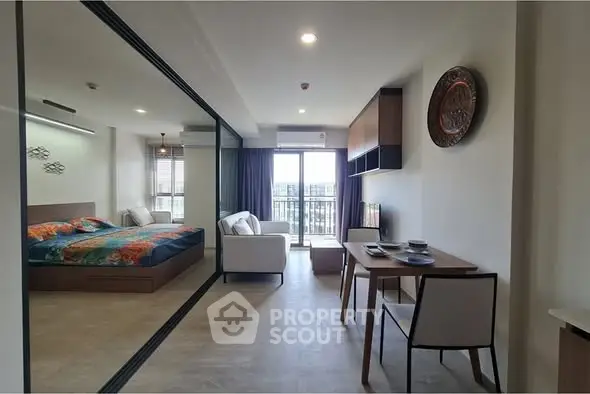 Modern studio apartment with stylish decor and balcony view