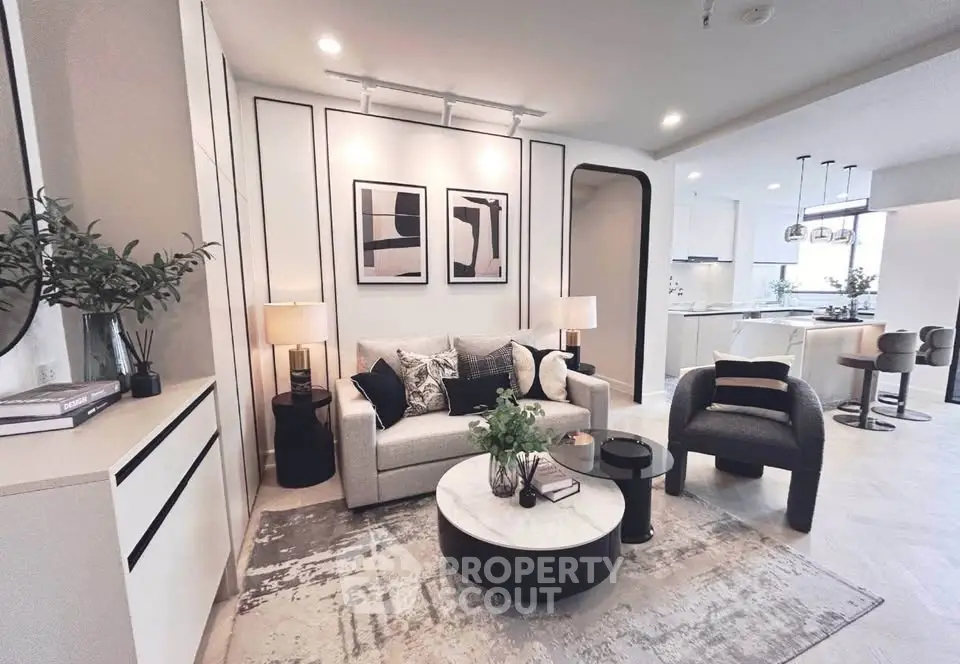 Modern living room with stylish decor and open kitchen layout, perfect for contemporary living.