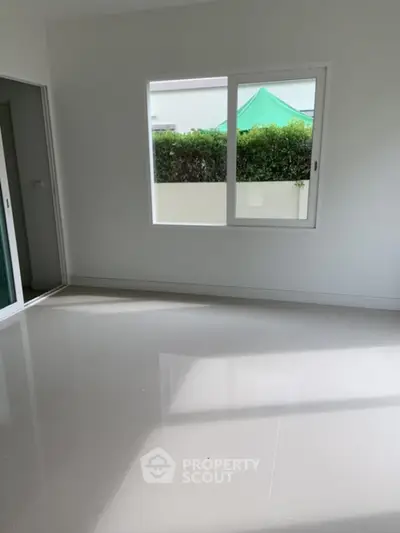 Bright empty room with large window and glossy floor tiles
