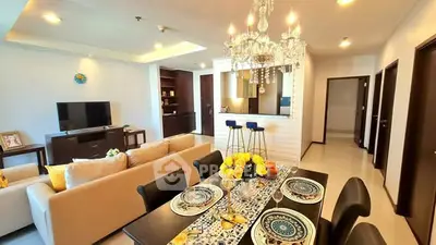 Luxurious open-plan living room with elegant chandelier and modern kitchen