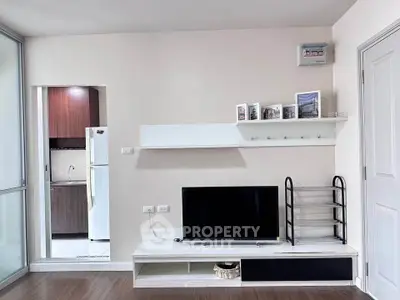 Modern living room with sleek TV stand and open kitchen view
