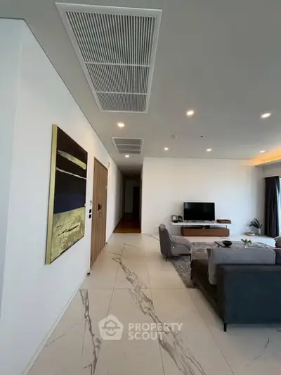 Spacious modern living room with elegant decor and large TV setup