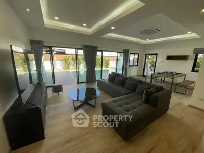 Spacious modern living room with elegant furniture and large windows for natural light