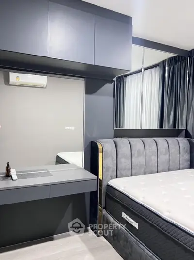 Modern bedroom with stylish grey decor and plush bed in contemporary apartment