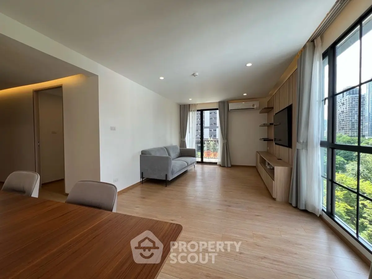 Spacious modern living room with large windows and city view