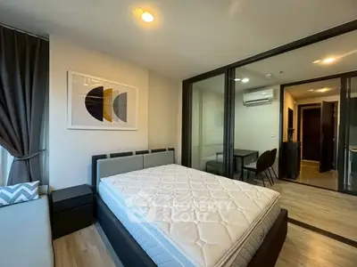 Modern bedroom with large bed and stylish decor in a contemporary apartment.