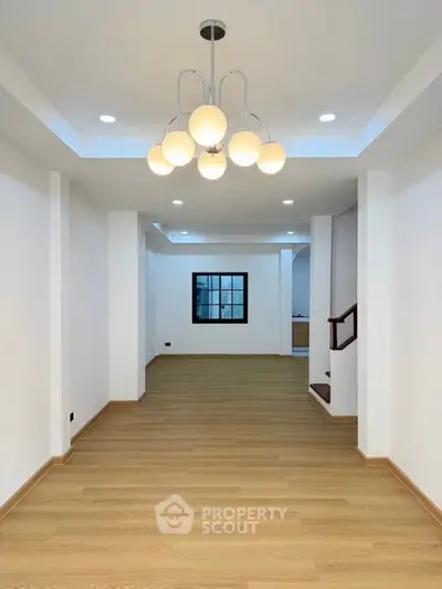 Spacious modern living room with elegant lighting and wooden flooring