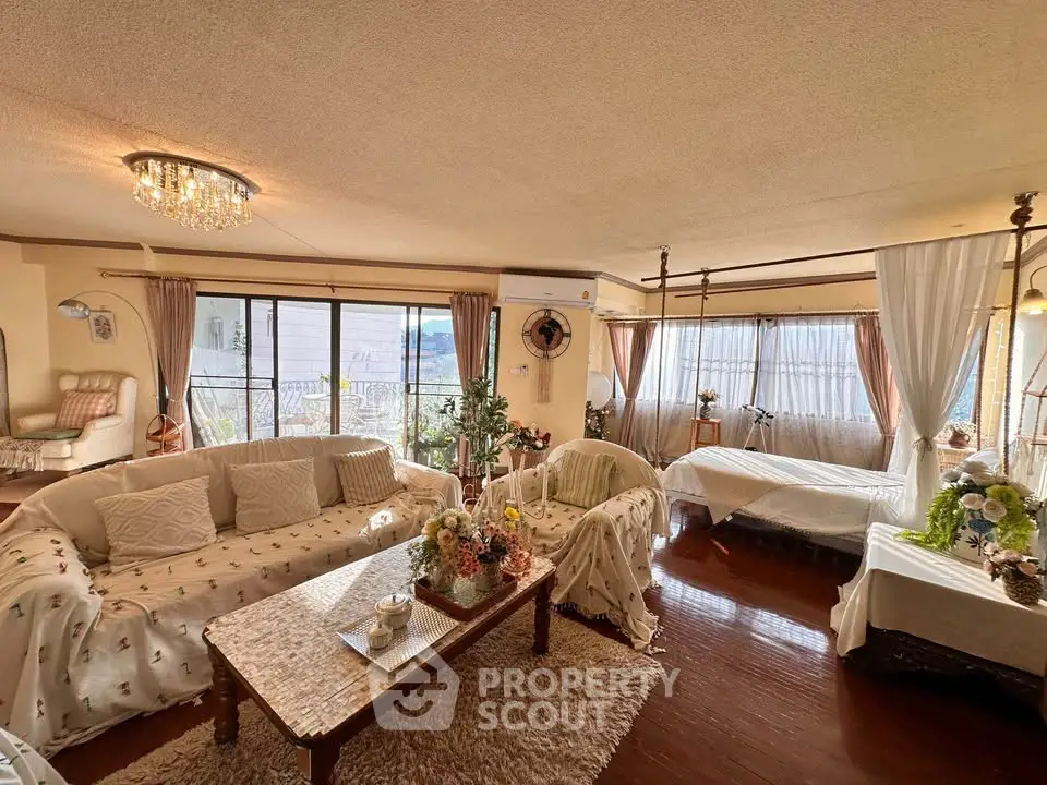 Spacious living room with elegant decor and large windows offering natural light.