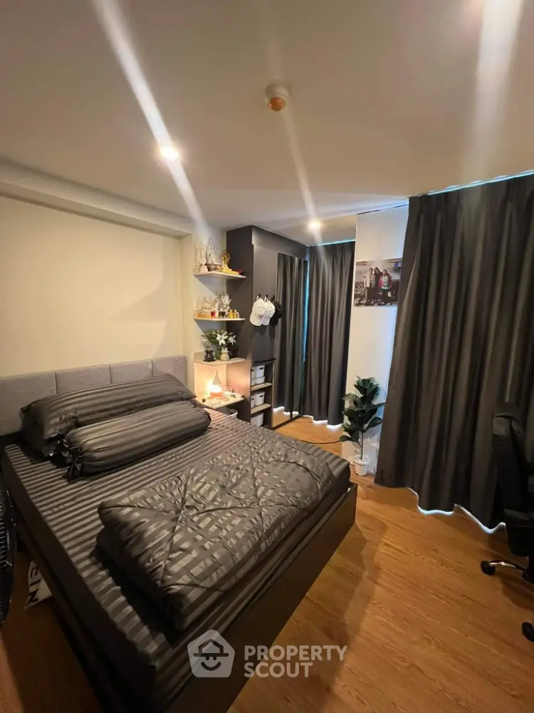 Cozy modern bedroom with stylish decor and ample natural light