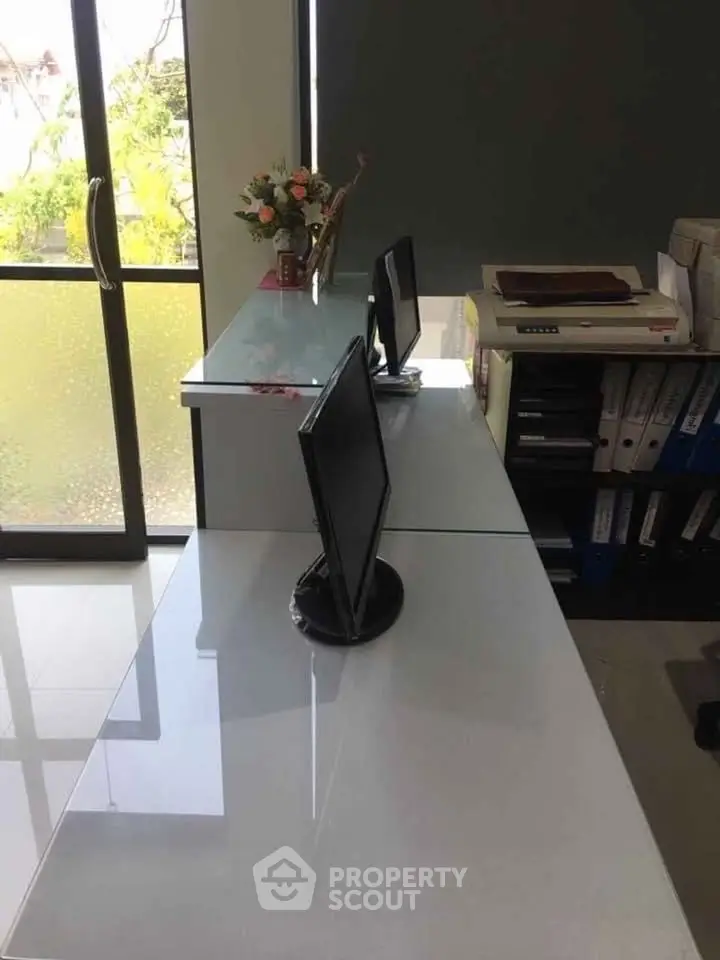 Modern office space with sleek desks and computer monitors, ideal for productivity and efficiency.