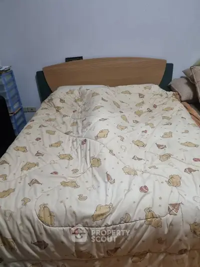 Cozy bedroom with charming animal-themed bedding and wooden headboard, perfect for a restful night's sleep.
