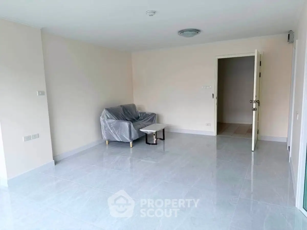 Spacious unfurnished living room with tiled flooring and natural light