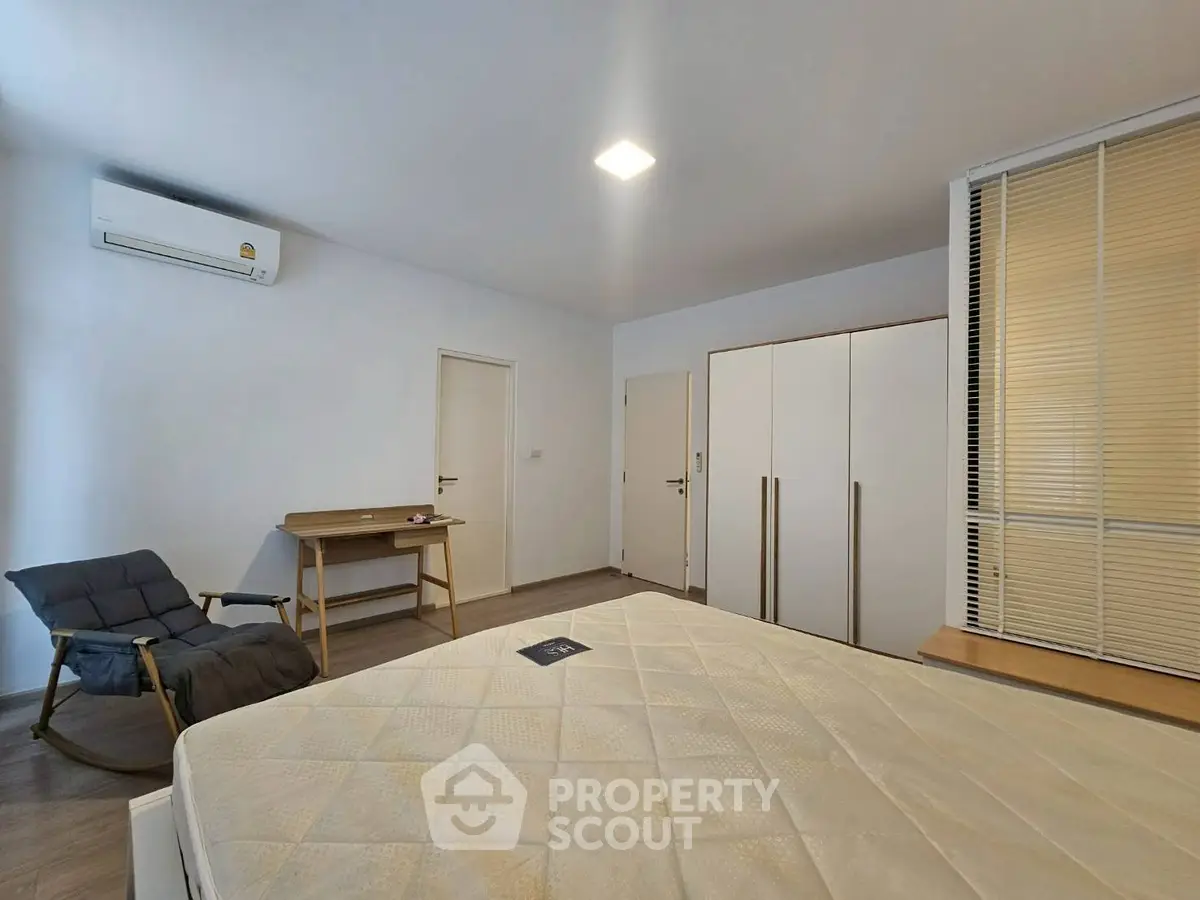 Spacious bedroom with modern furniture and air conditioning, perfect for comfort and relaxation.