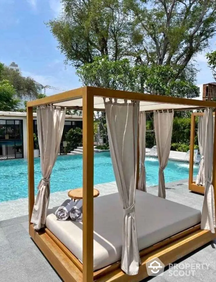 Luxurious poolside cabana with elegant drapery and serene ambiance