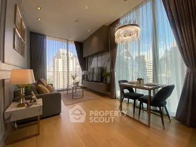 Luxurious living room with floor-to-ceiling windows and elegant chandelier in modern high-rise apartment.