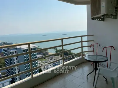 Stunning ocean view from high-rise balcony with seating area