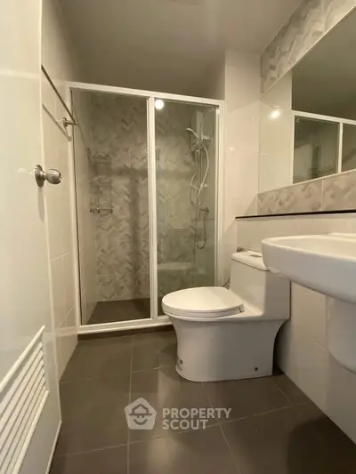 Modern bathroom with glass shower and sleek fixtures