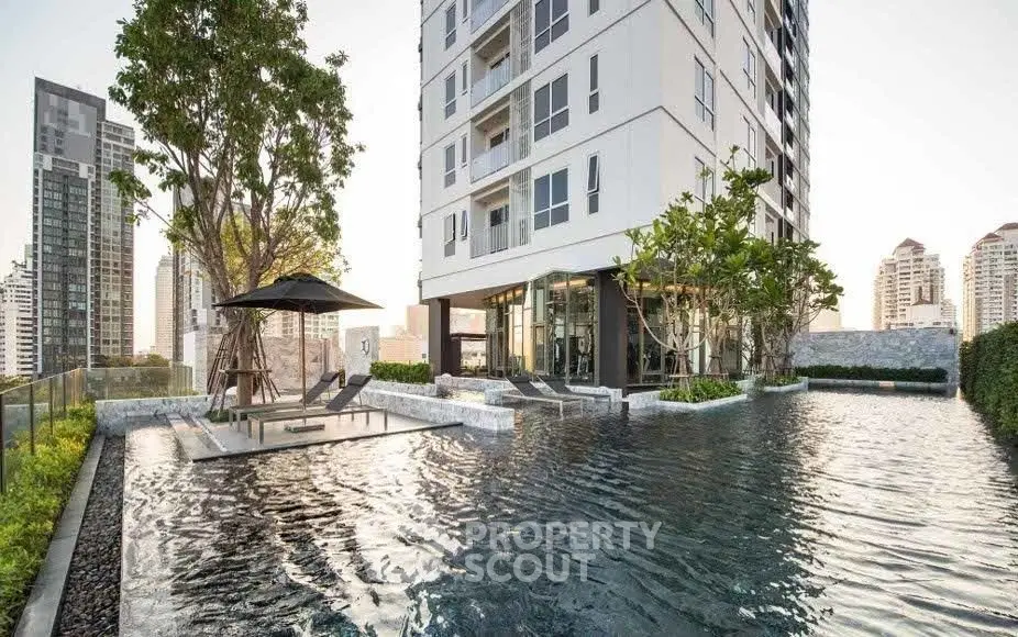 Luxurious high-rise building with stunning pool and city views, perfect for urban living.