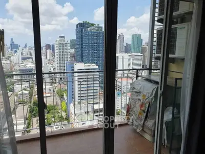 Stunning cityscape view from a high-rise balcony with modern skyline.