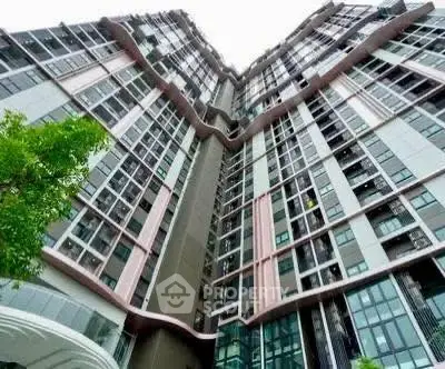 Stunning modern high-rise building with unique architectural design and expansive glass windows.