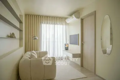 Modern minimalist living room with cozy sofa, wall-mounted TV, and large window with sheer curtains.